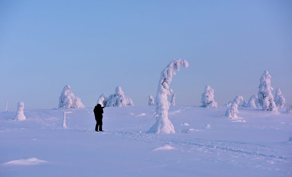 Photographer in snowy landscape